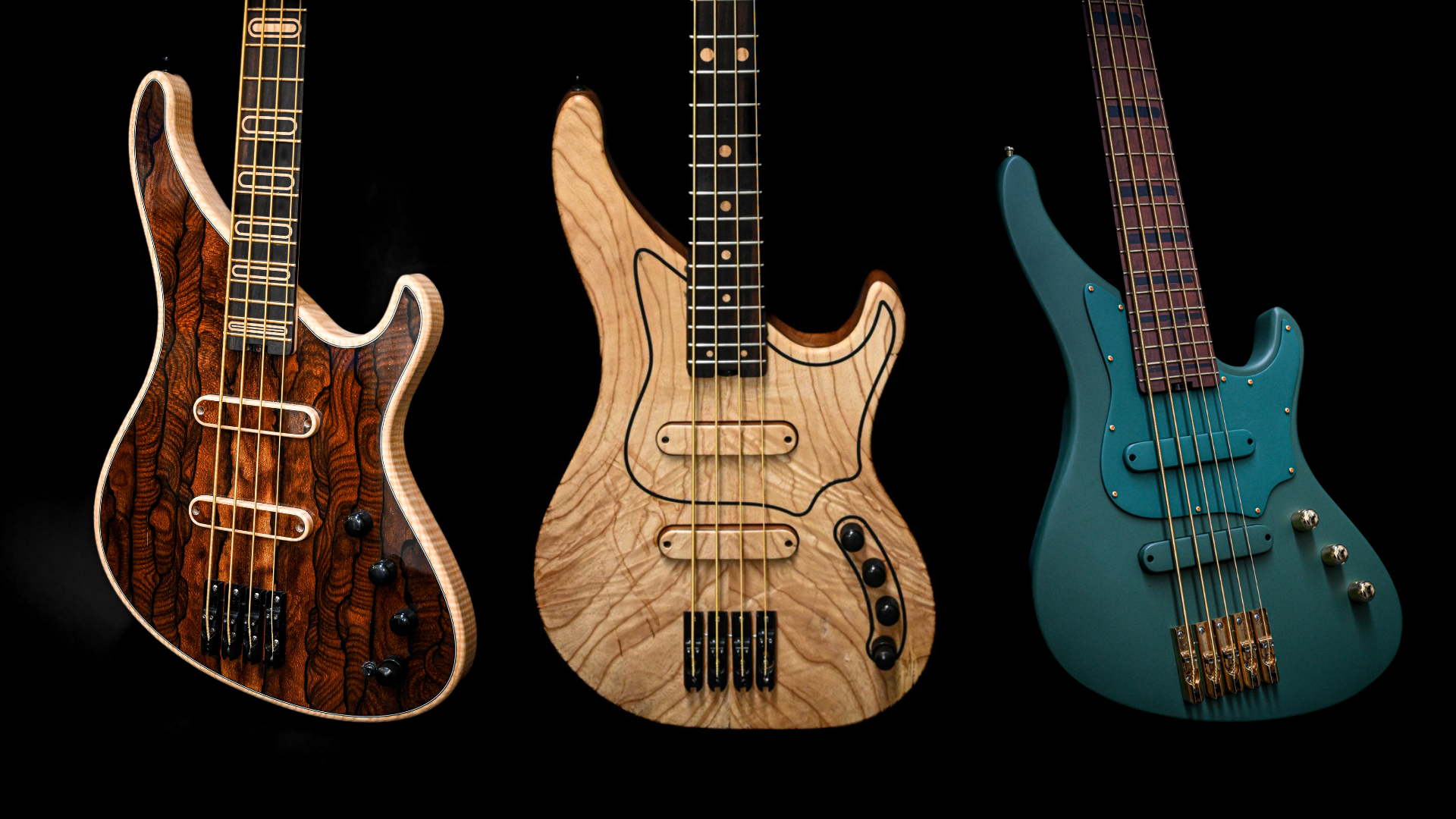 Three unique electric bass guitars with distinct woods and finishes displayed against a black background.