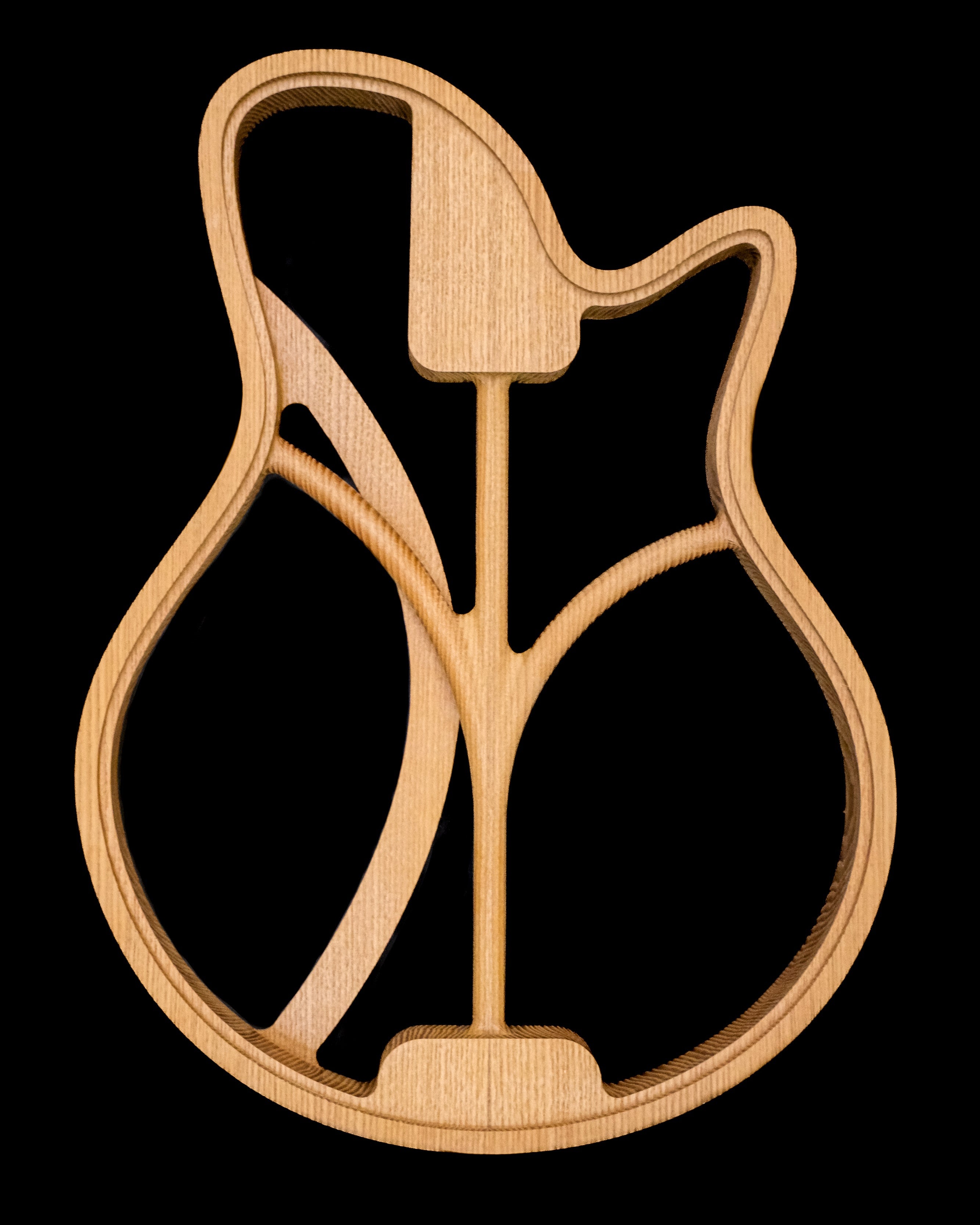 Wooden guitar shape cutout showcasing intricate design details and craftsmanship.