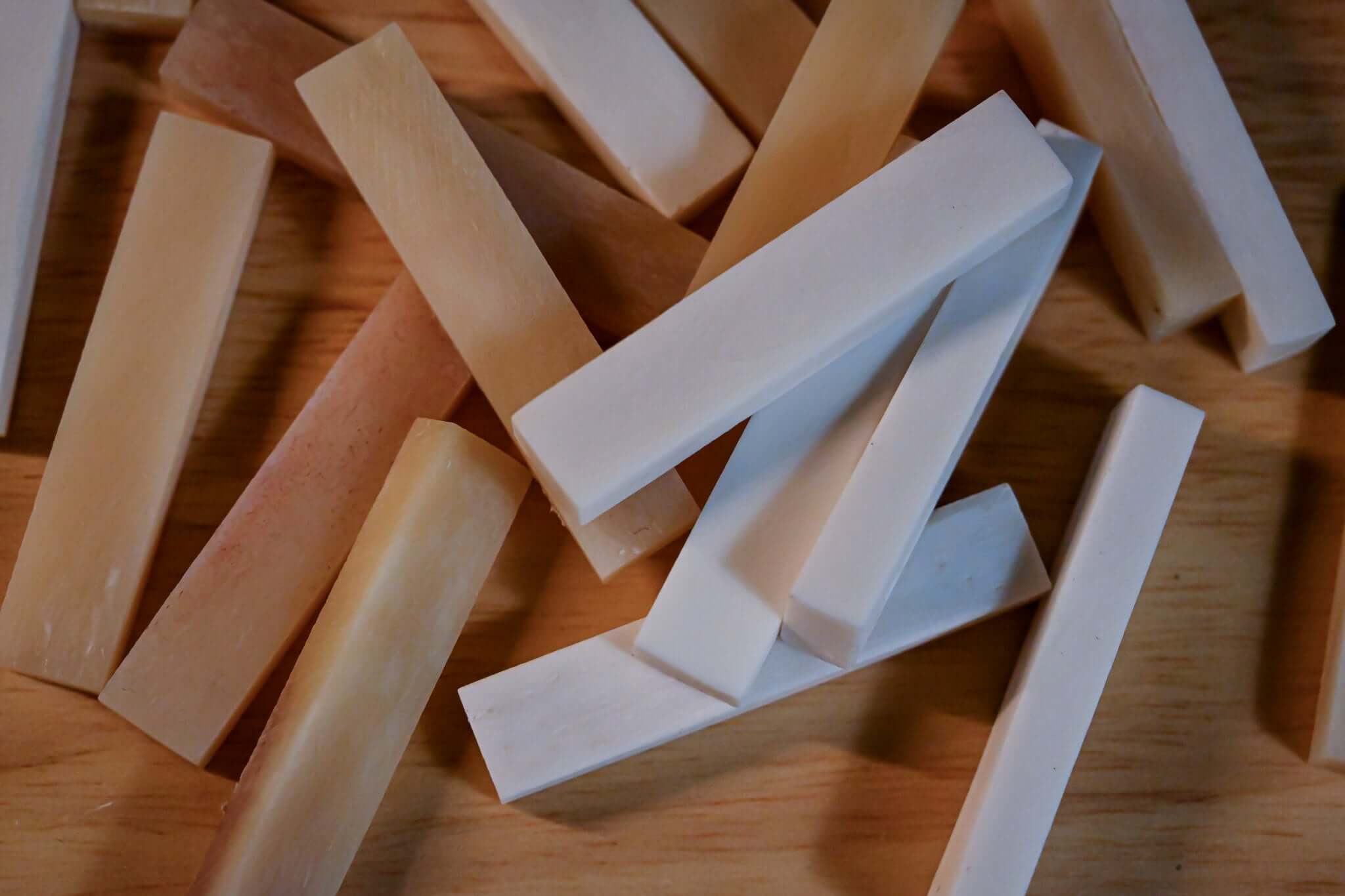 A shot of different bone nut blanks used in production at Belforti Instruments Paris