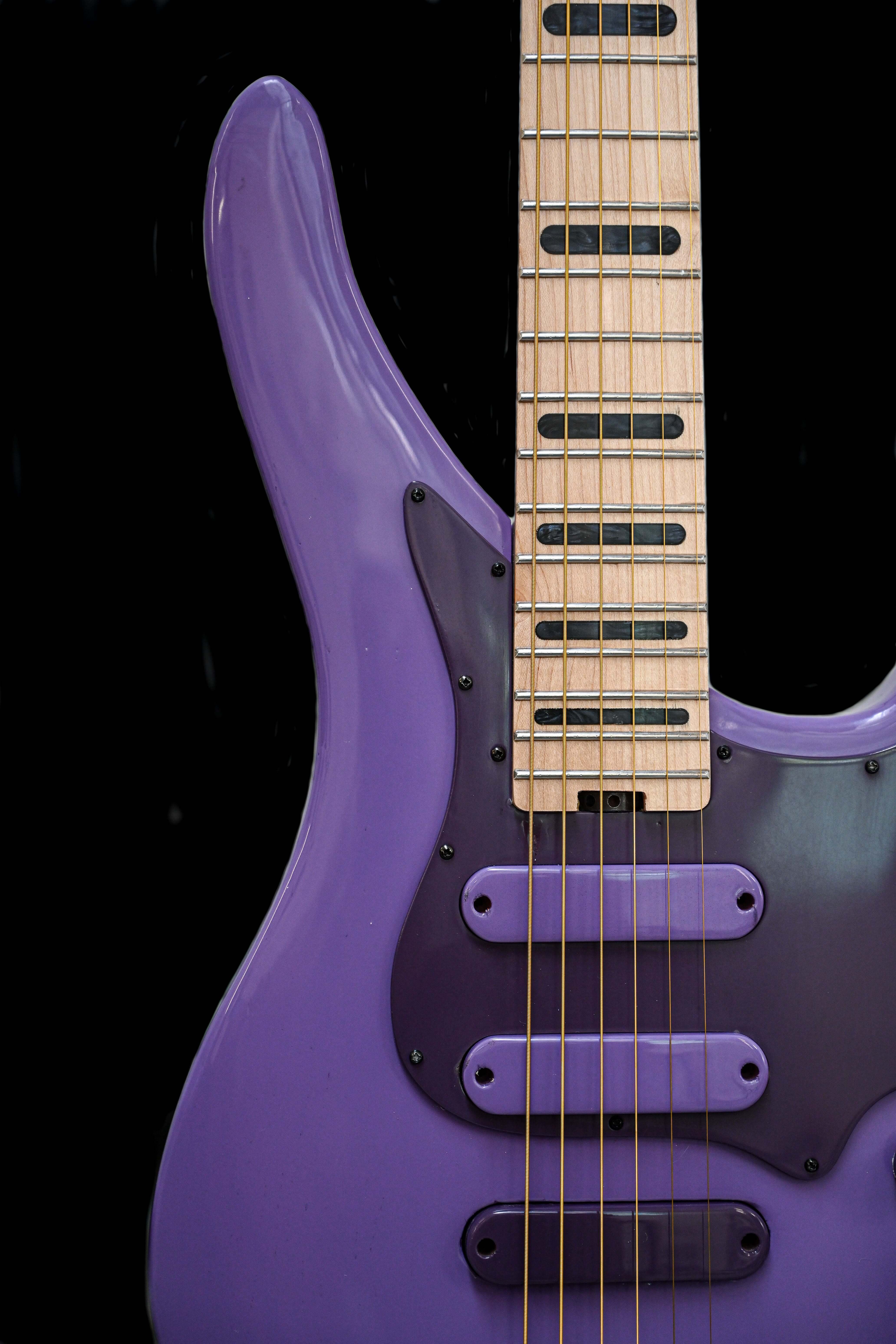 Close-up view of the E5 French Lilac guitar, highlighting its unique purple body and detailed fretboard.