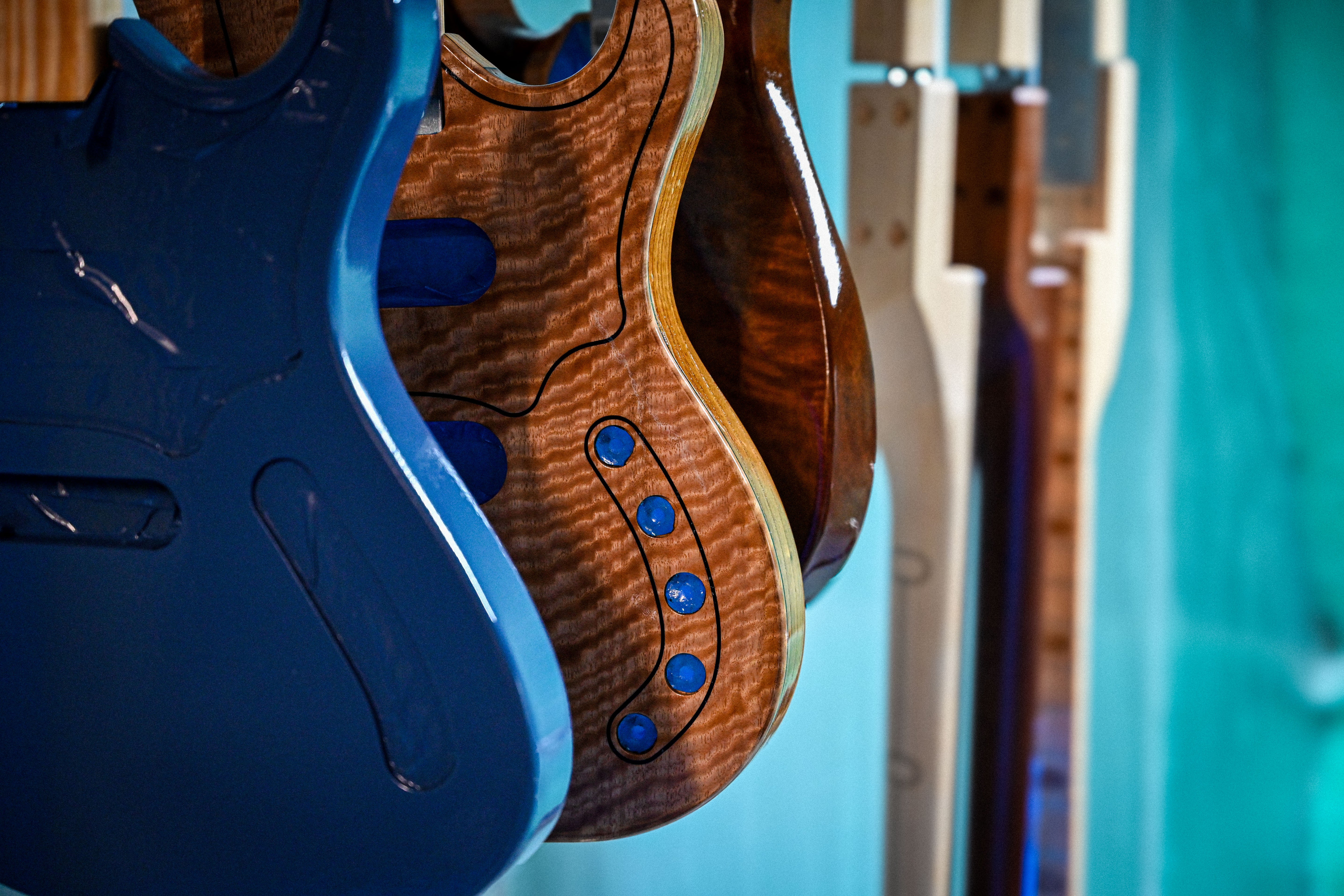 Belforti Basses and guitars being spray, curing and drying in the spray booth at the Belforti Manufacture in Paris France