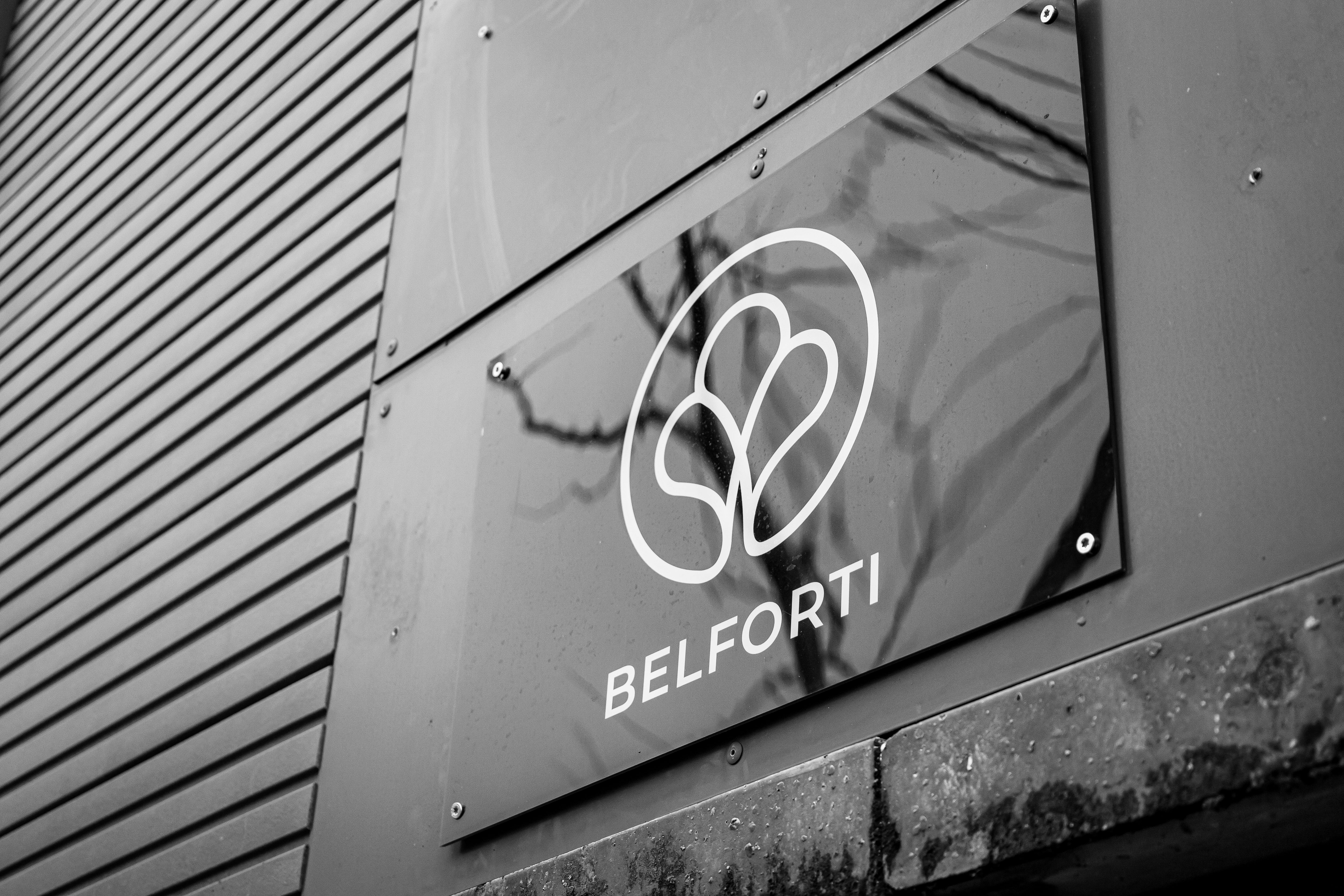 Belforti logo on a modern building facade in black and white