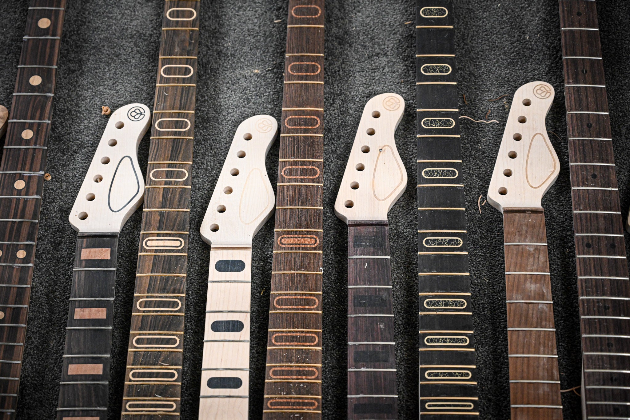 A series of Belforti guitars and necks next to each other