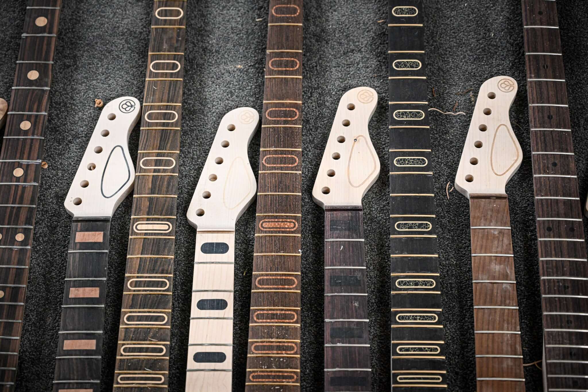 A series of Belforti guitars and necks next to each other