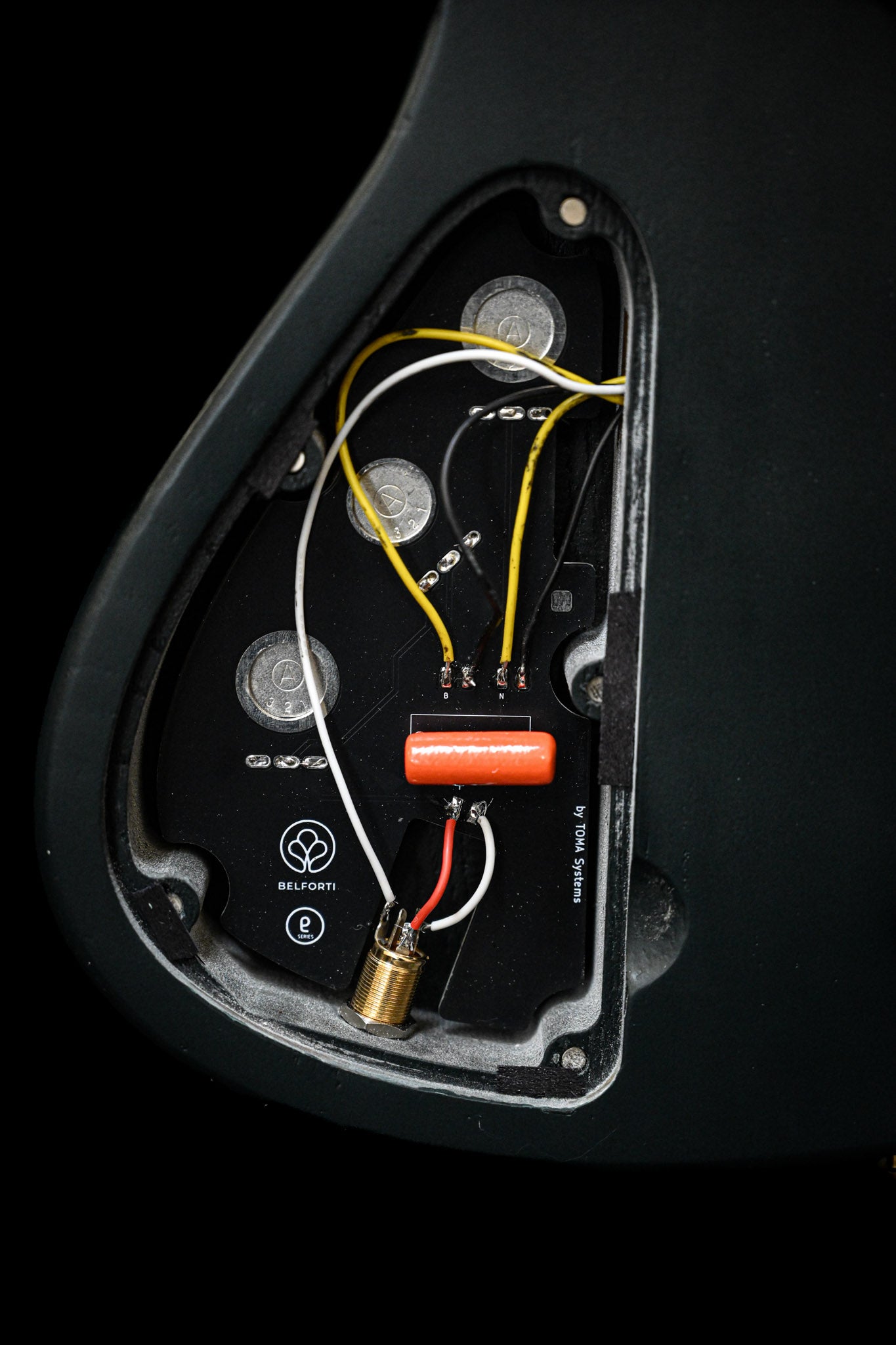 A close up shot of the electronic cavity of a Belforti Bass, featuring Belforti's onboard PCB crafted and designed by TOMA Systems