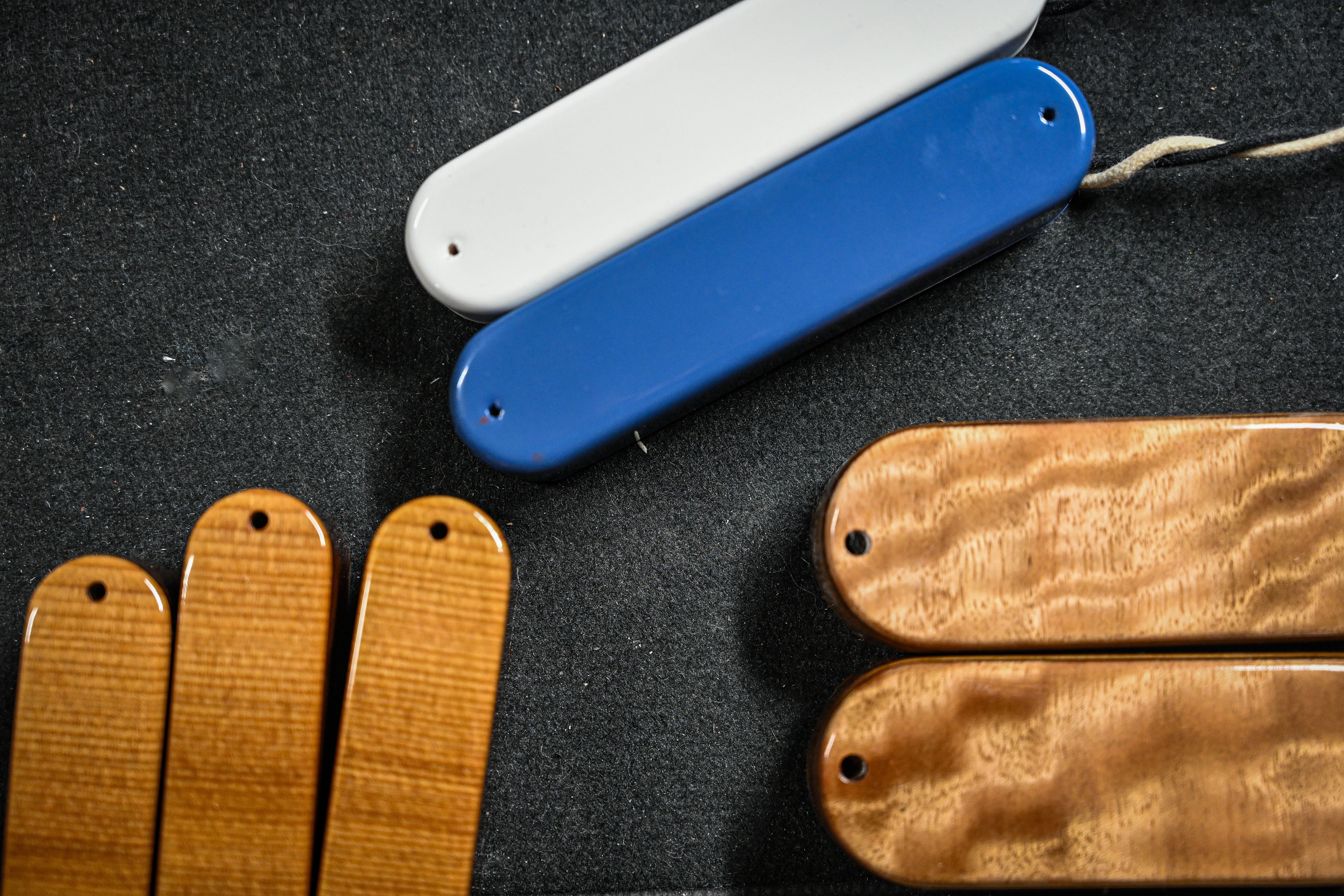 A descriptive view of Belforti's signature pickup shells, made out of wood matching the guitar and basses tops or paint