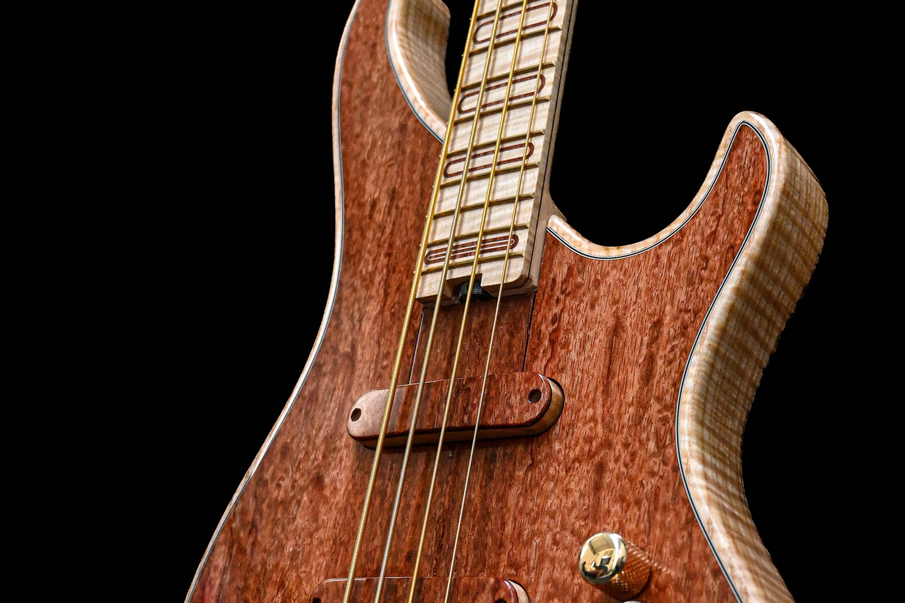 An artisty shot of the Belforti S1 Bubinga, showcasing the signature inlayed top design, matching pickup shells and intricate details