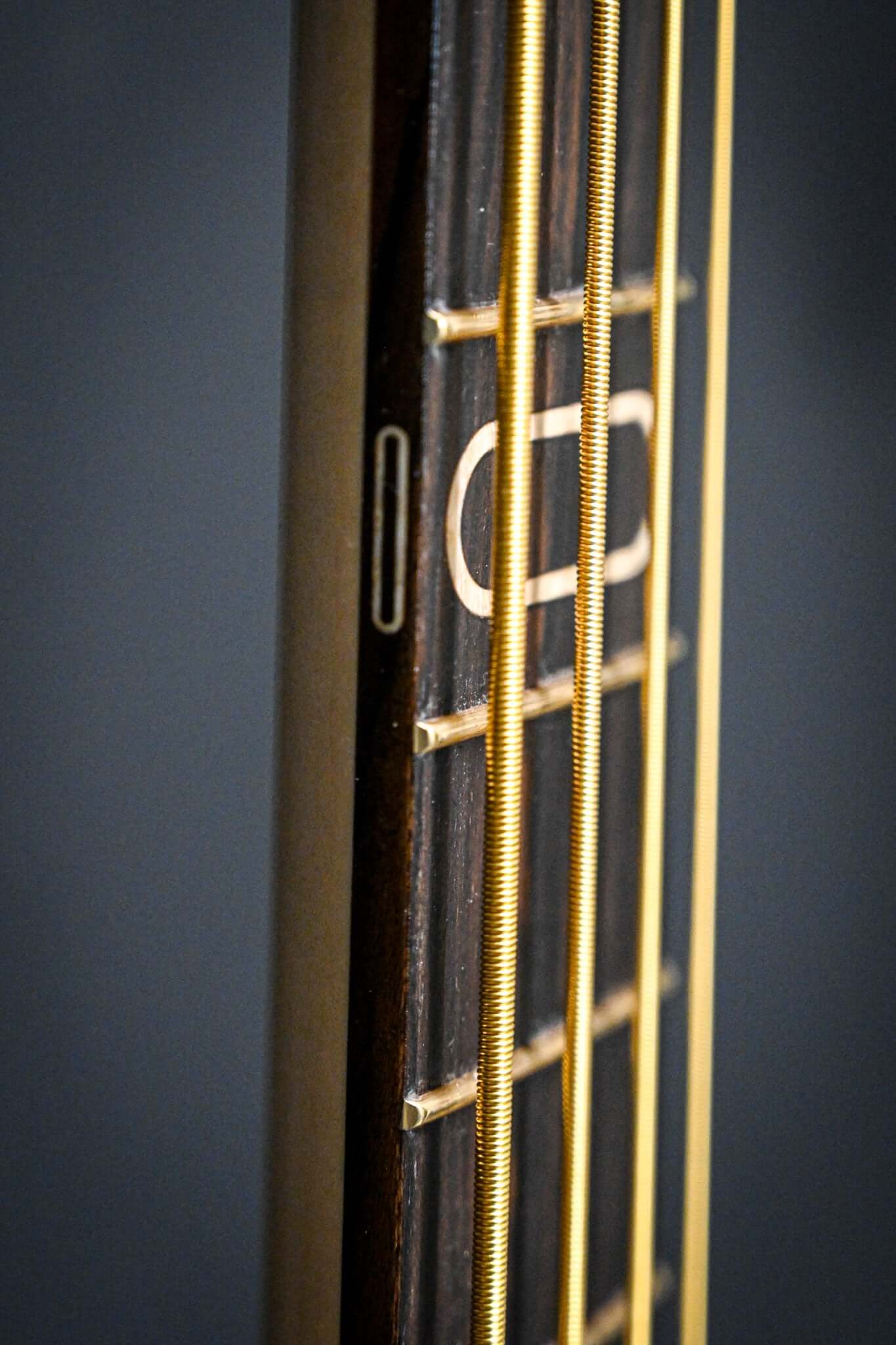 A detailed view of the Belforti S1 Ziricote Side dots with a fine art deco style and matching wood