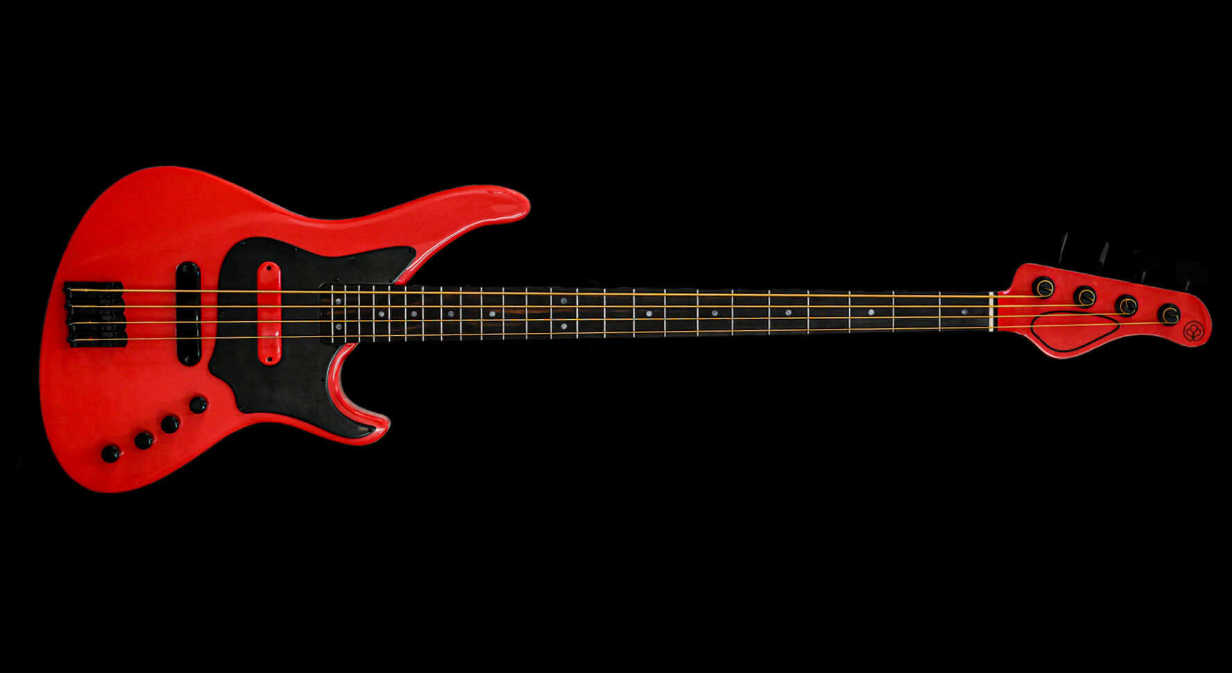 Red electric bass guitar on black background, featuring black pickguard and detailed strings.