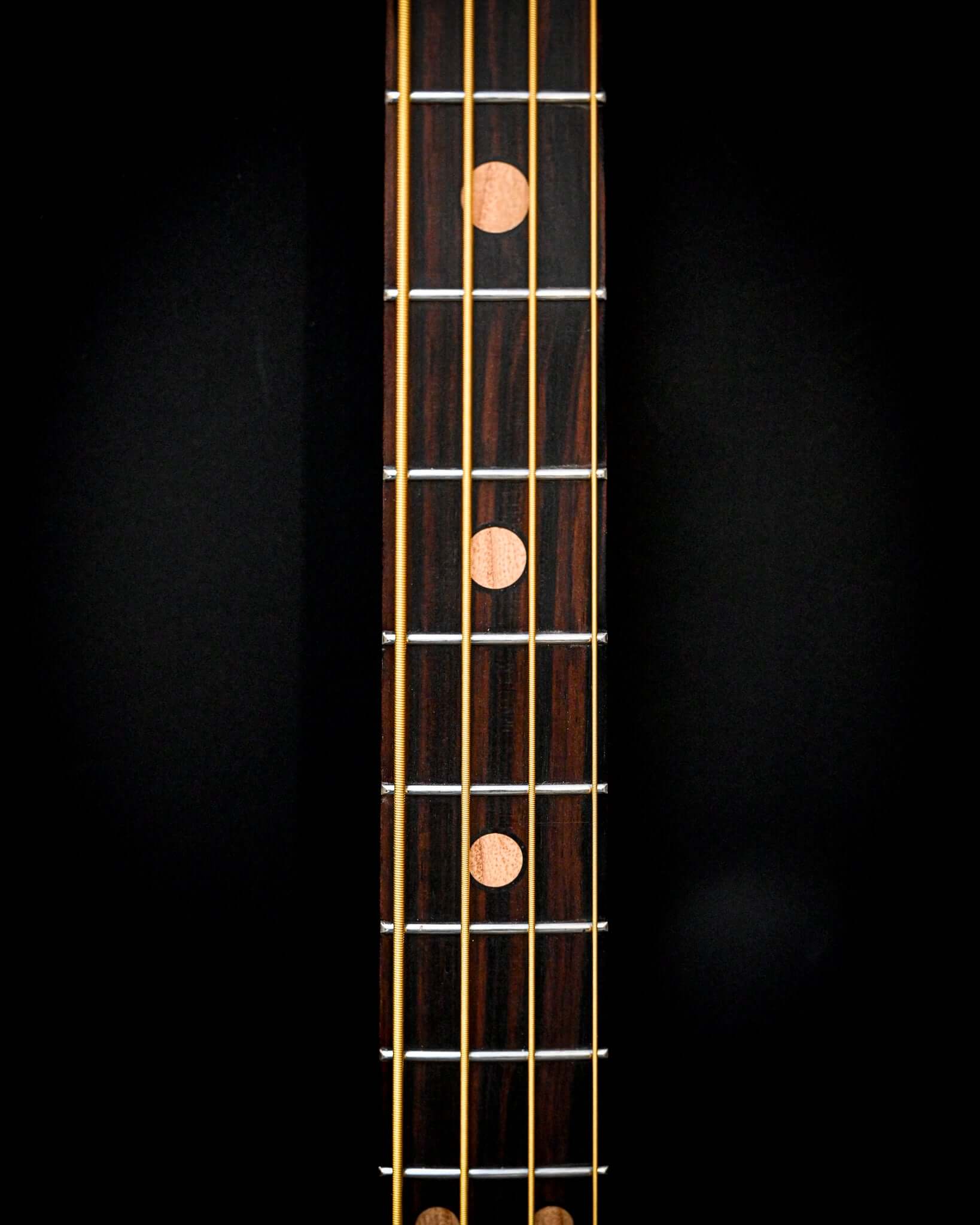 M3 Maple bass guitar viewed from above, capturing the body and neck alignment.