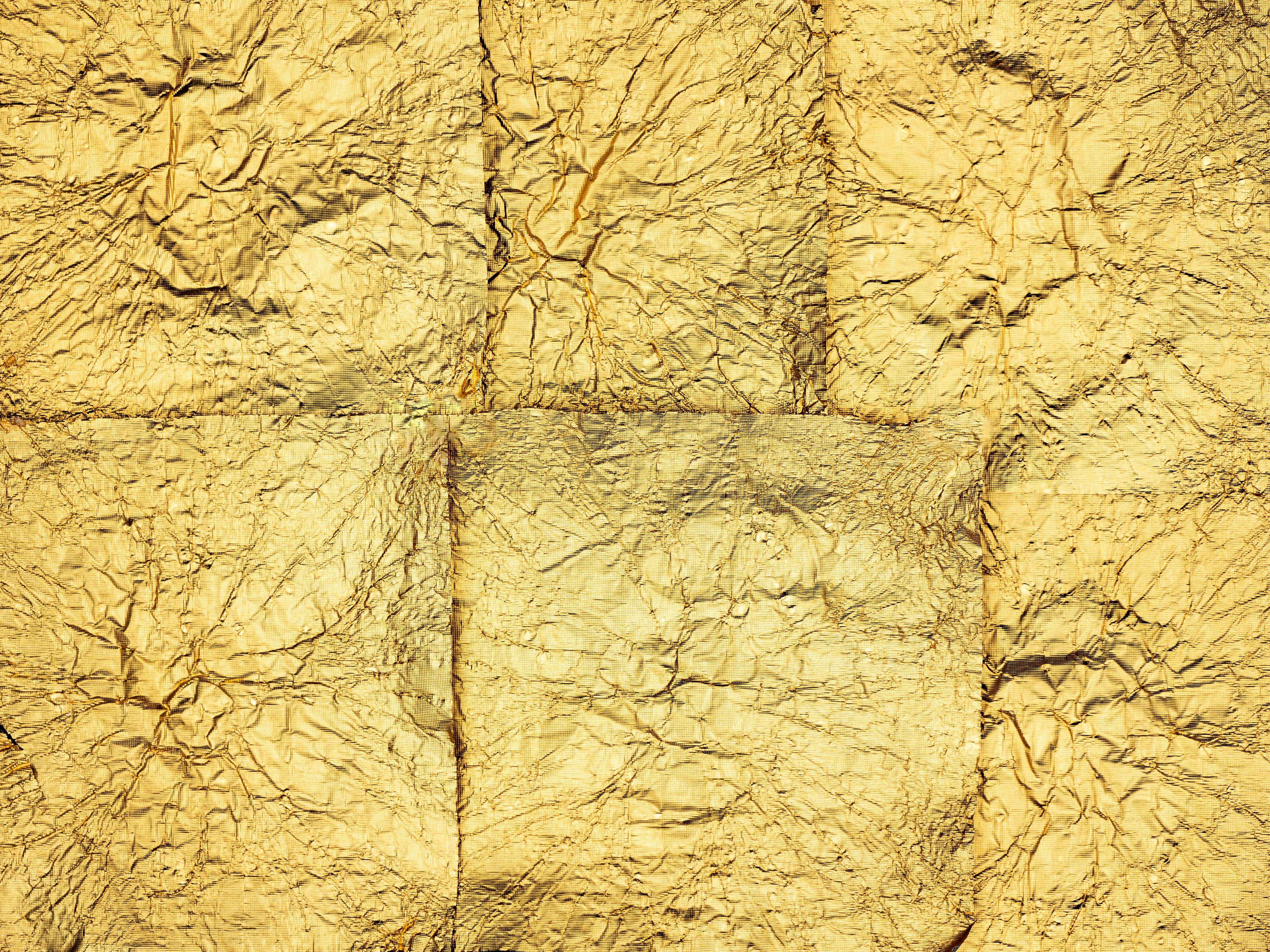 Zoomed out view of gold foils on a surface