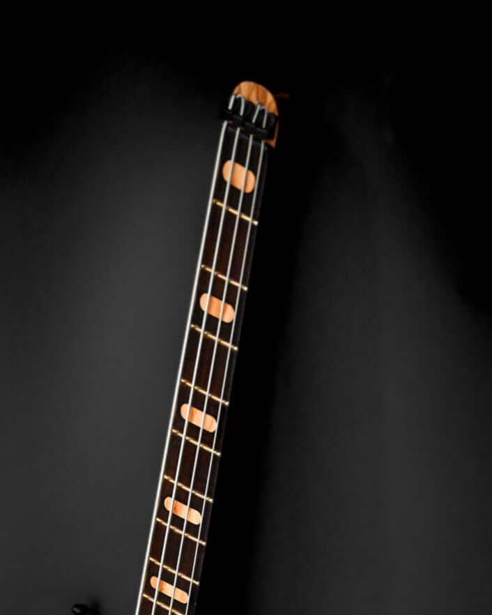 A cropped view of the Mare Headless Short Scale neck made out of roasted maple and olive