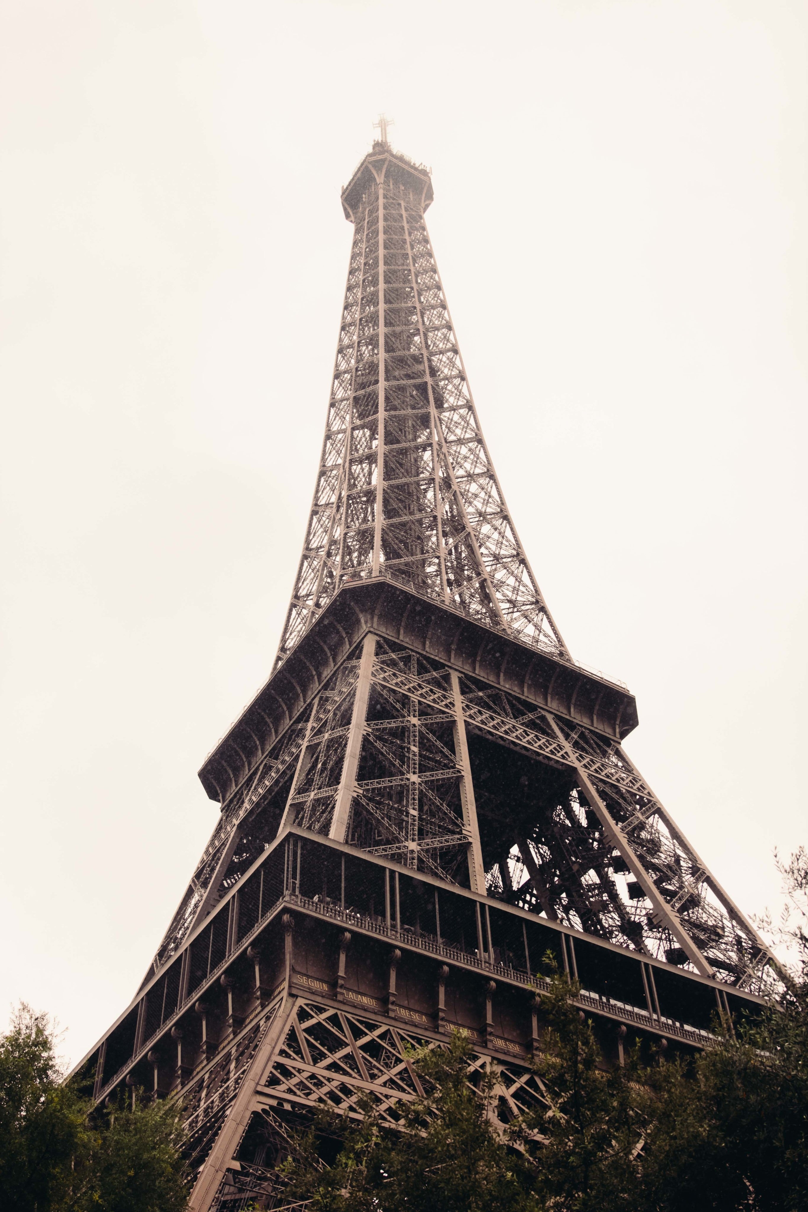 a view of the eiffel tower from the bottom on a cloudy day