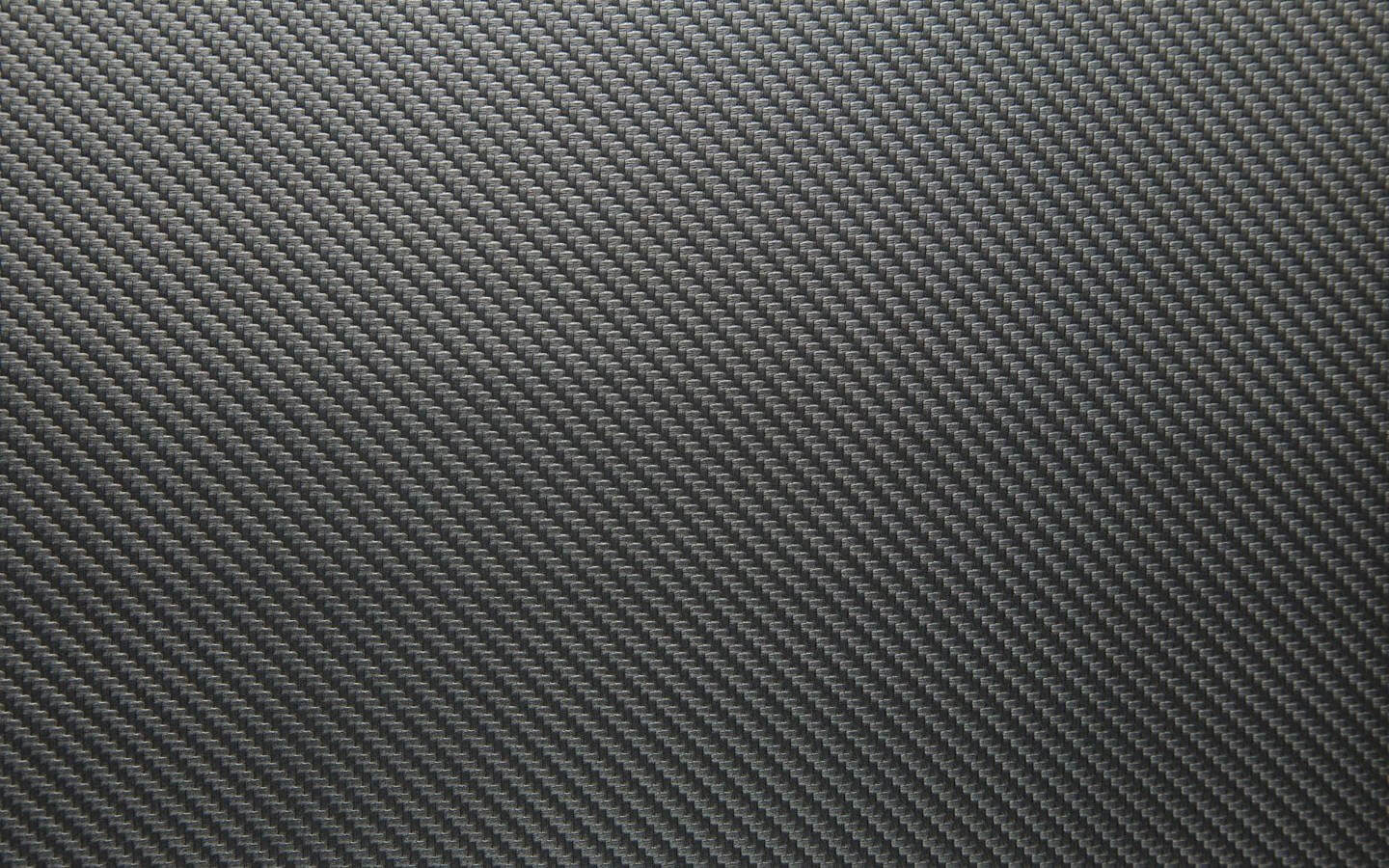 Close-up of black carbon fiber texture pattern background.