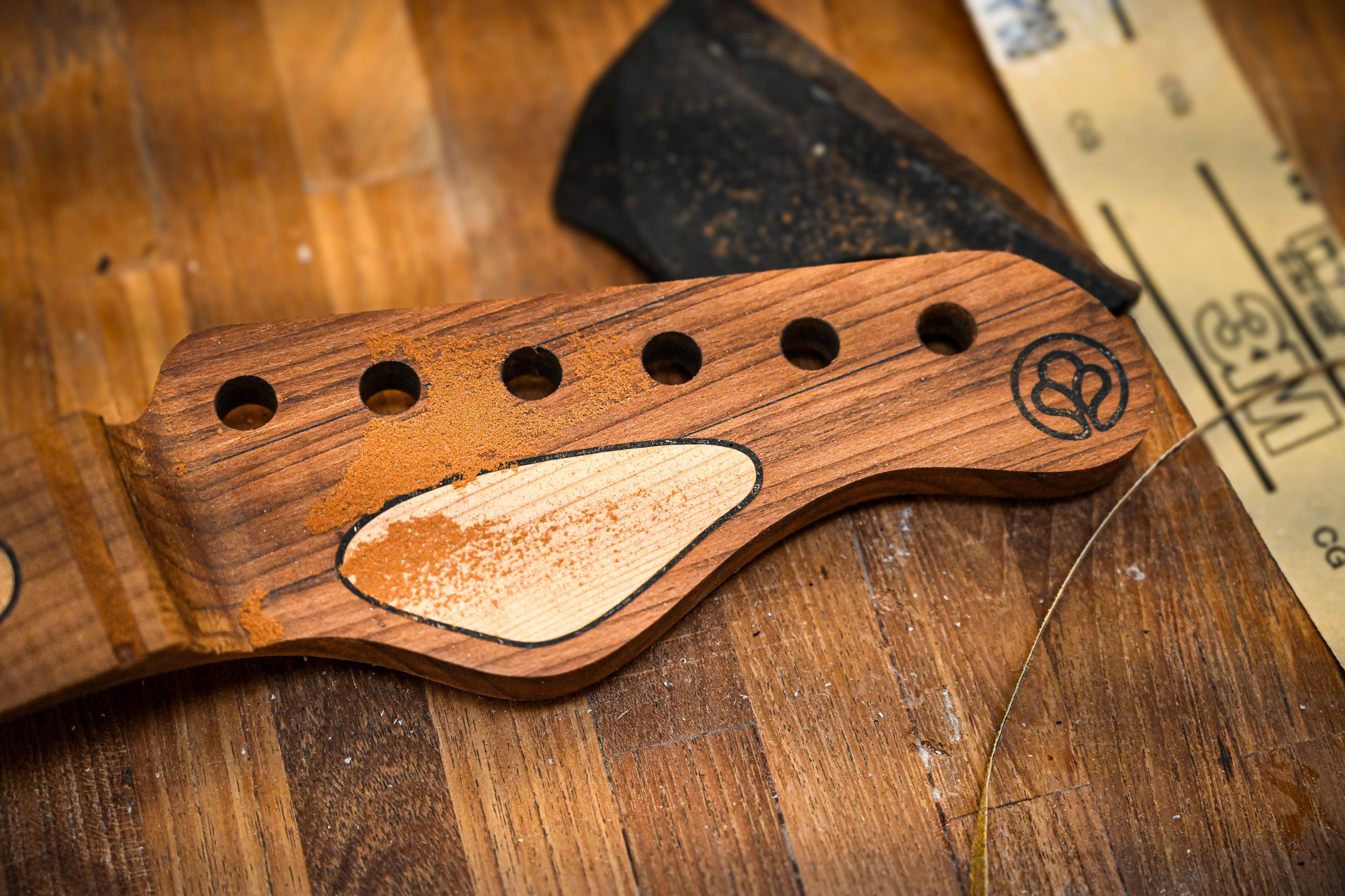 A close up view of a Belforti headstock and headstock inlay