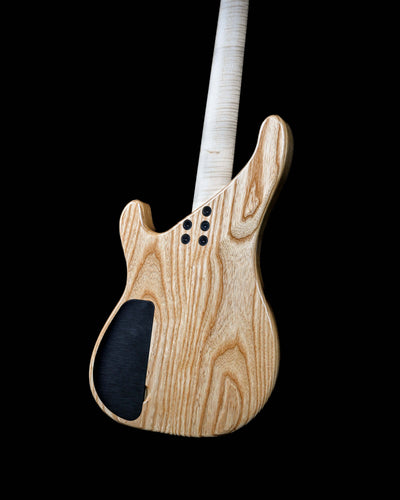 Vēa 4 - Essential bass guitar by Belforti, showcasing elegant woodgrain finish, custom boutique design, high-end luxury instrument.