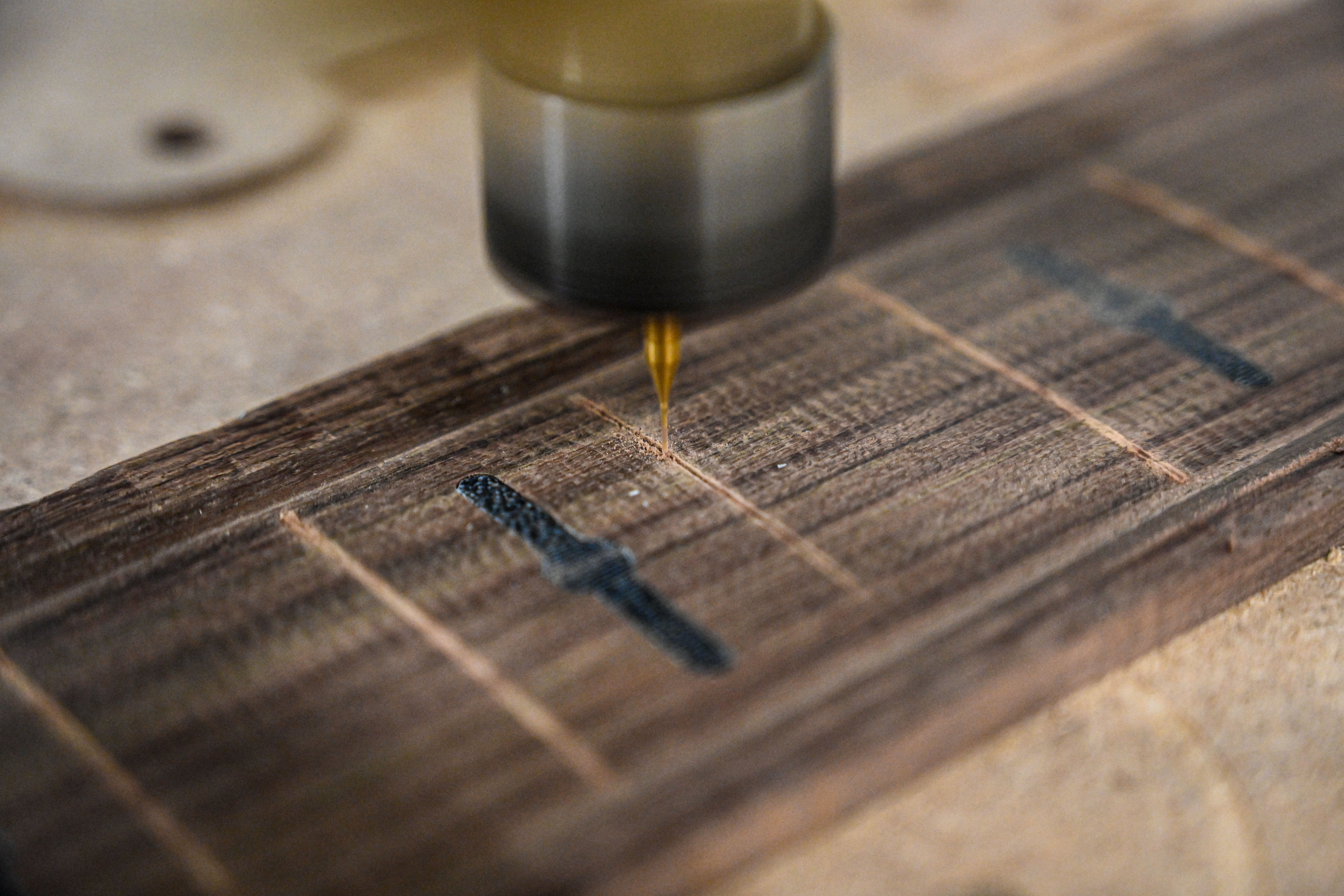 A close view of Belforti's CNC Machine machining fretslots on a rosewood fretboard