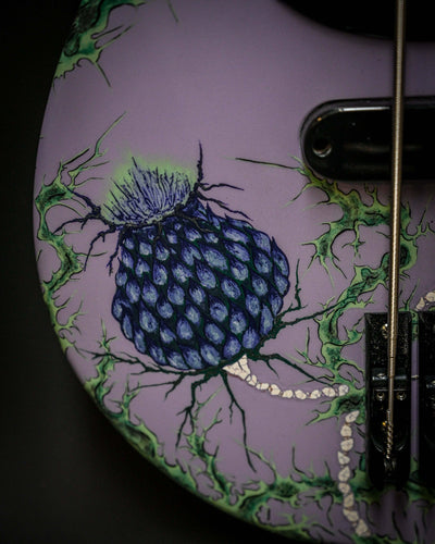 Close-up of custom design on Belforti Vēa 5 - Essential bass guitar with purple floral pattern, luxury high end boutique instrument.