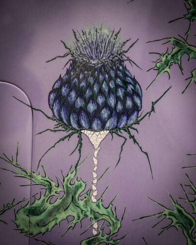 Close-up of a detailed thistle design on a Vēa 5 - Essential bass guitar by Belforti, showcasing boutique and high-end craftsmanship.