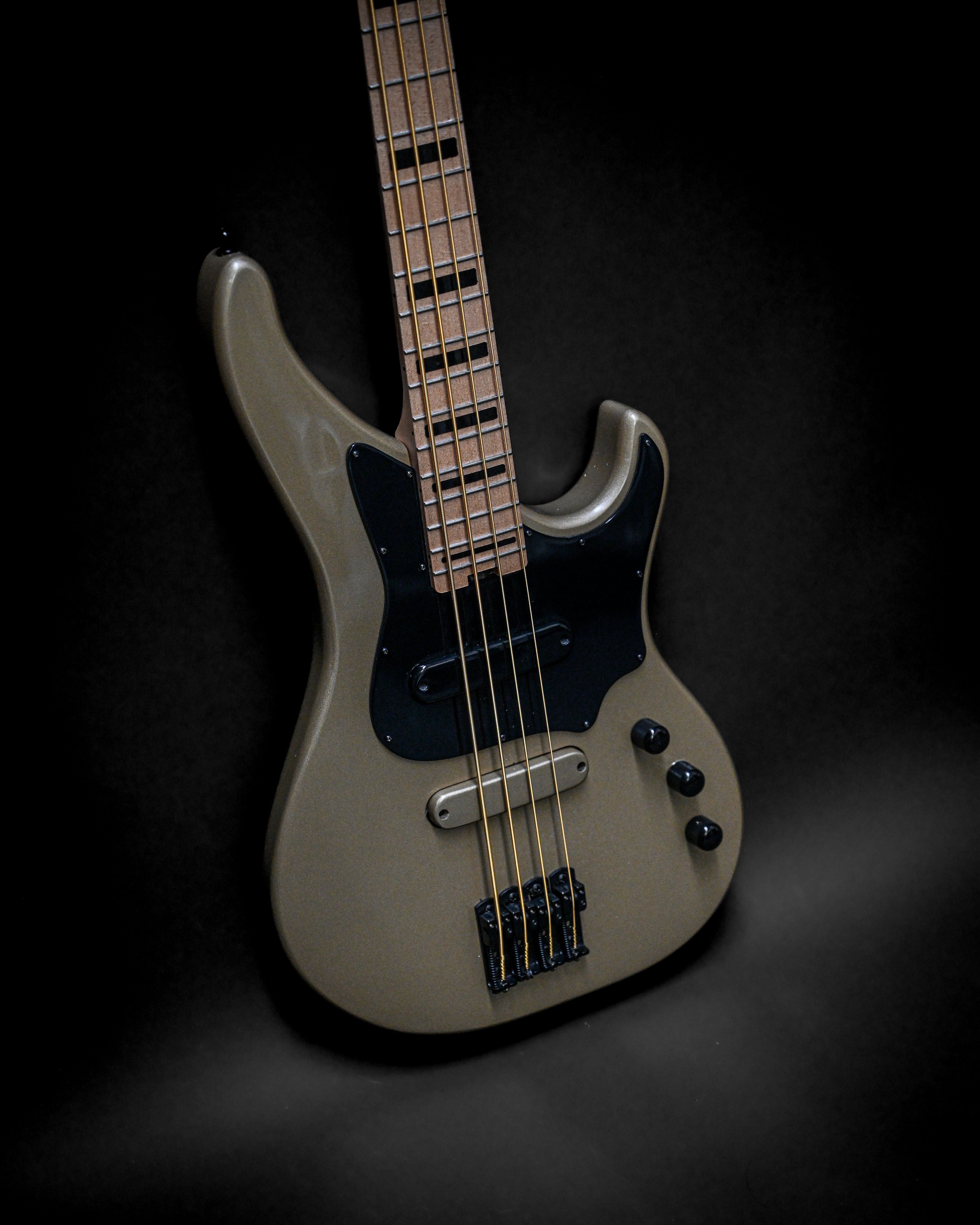 Belforti electric bass guitar with maple neck and dark body against black background