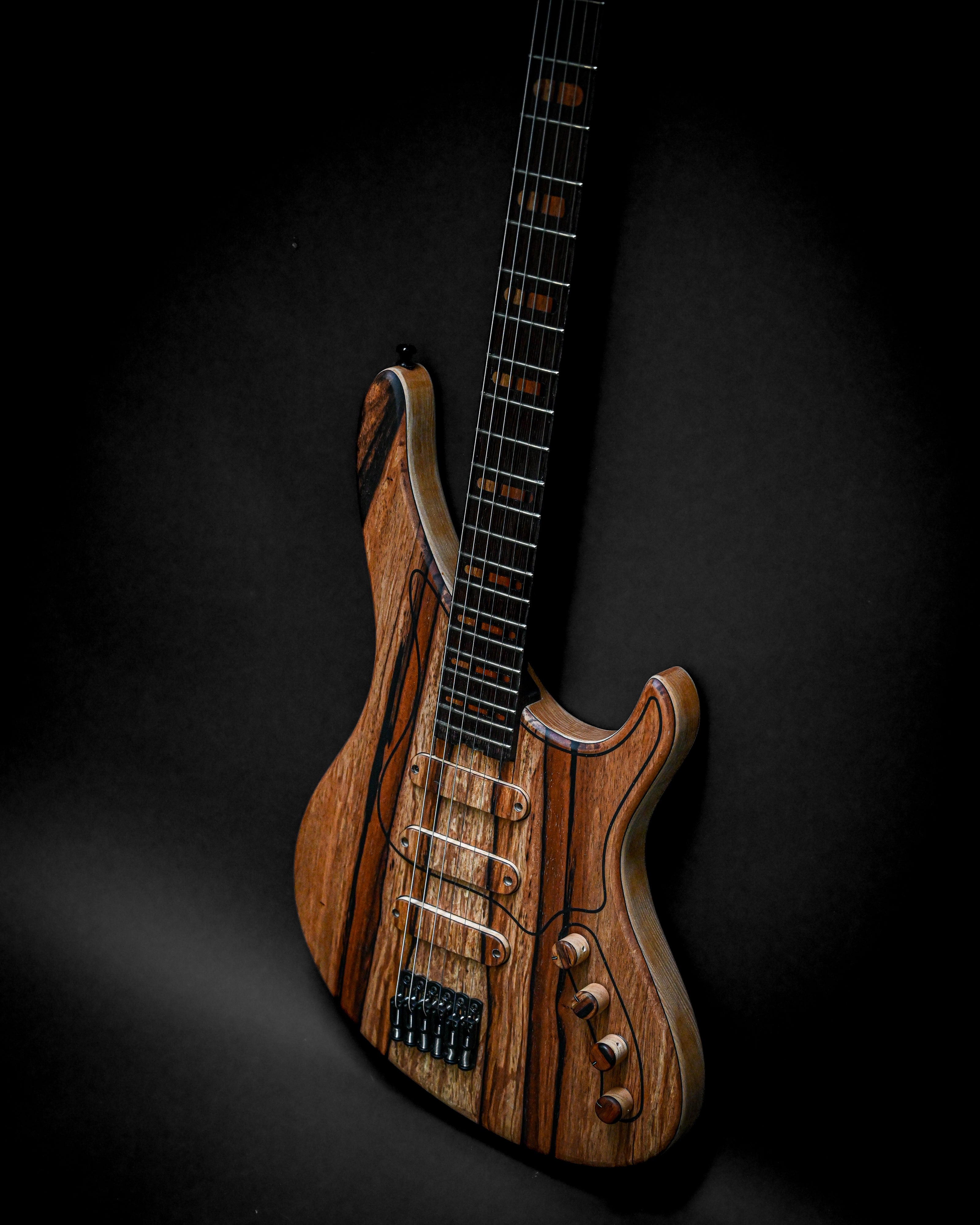 Sarā 6 - Masterbuilt custom electric guitar with luxurious tonewood body and bespoke hardware, designed for superior performance.