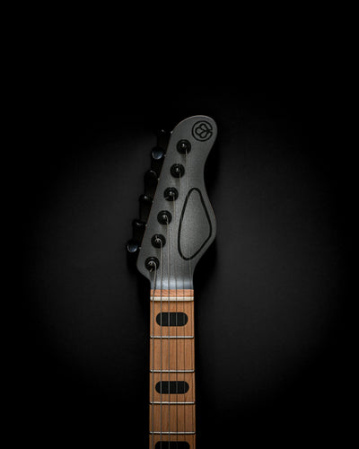 Sarā 6 - Essential custom electric guitar headstock on black background