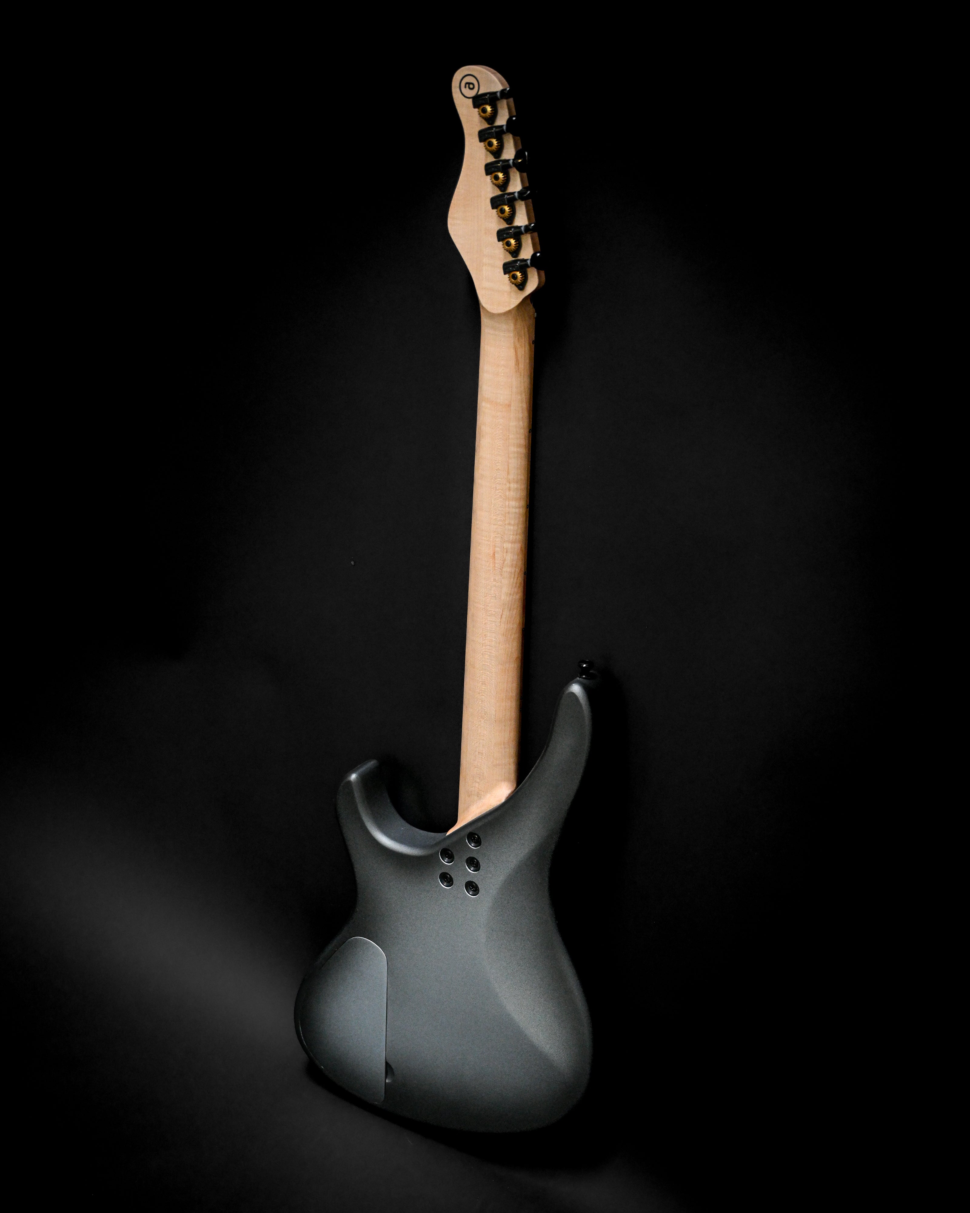 Sarā 6 - Essential custom electric guitar by Belforti, showcasing sleek back design and maple neck on black background.
