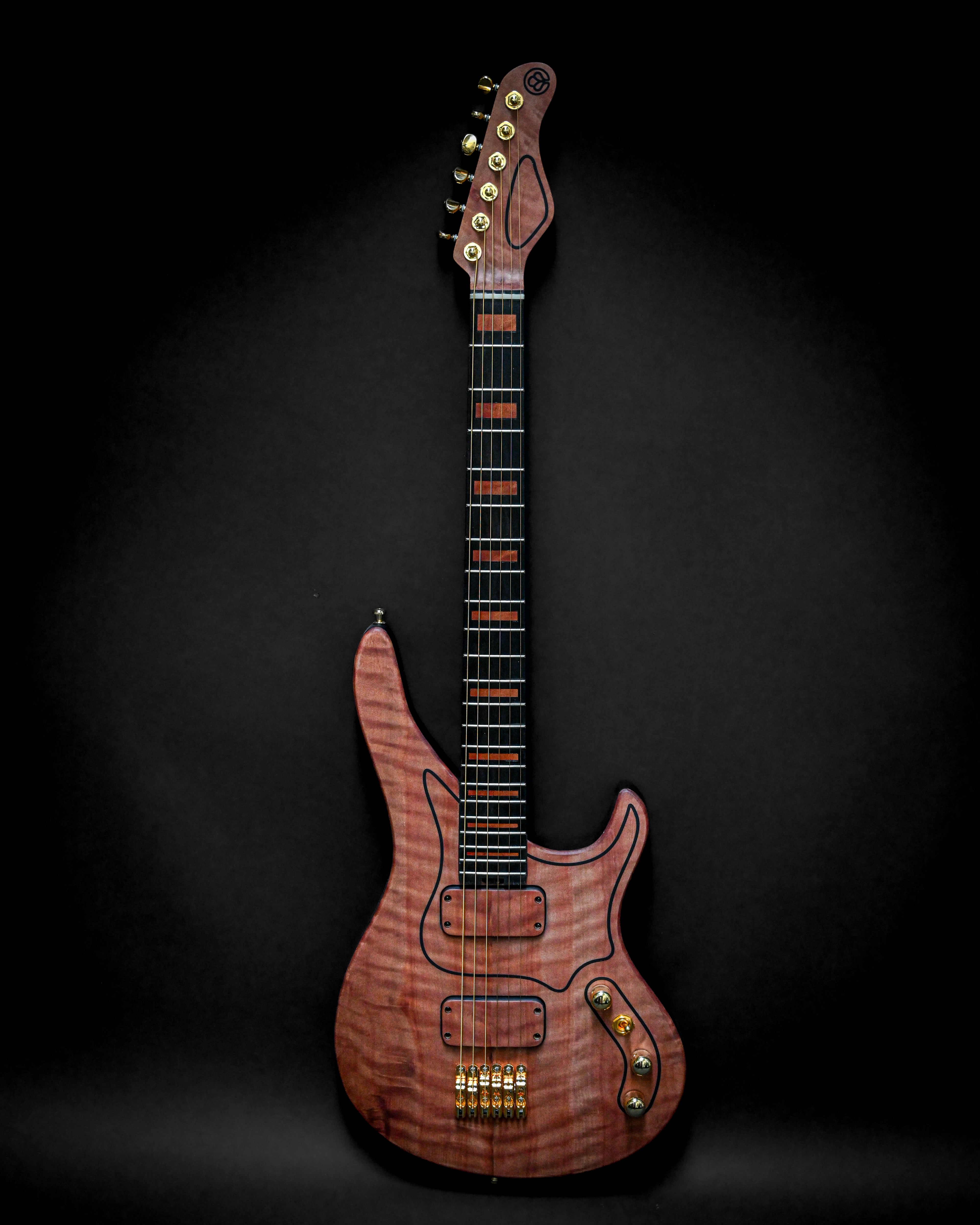 Elegant wooden electric guitar with a sleek modern design against a dark background.
