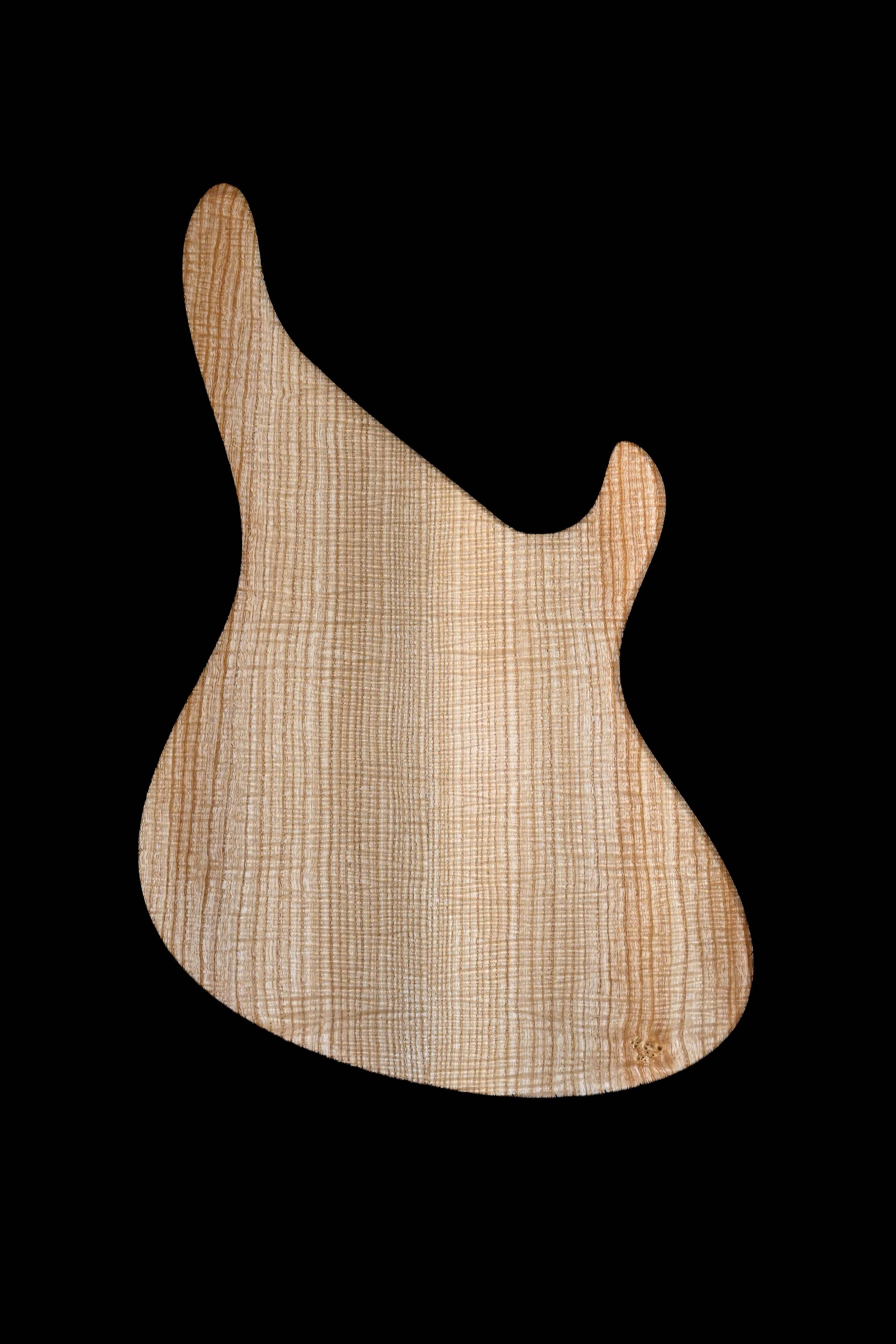 Wooden guitar body template on black background, ideal for luthiers and instrument makers.