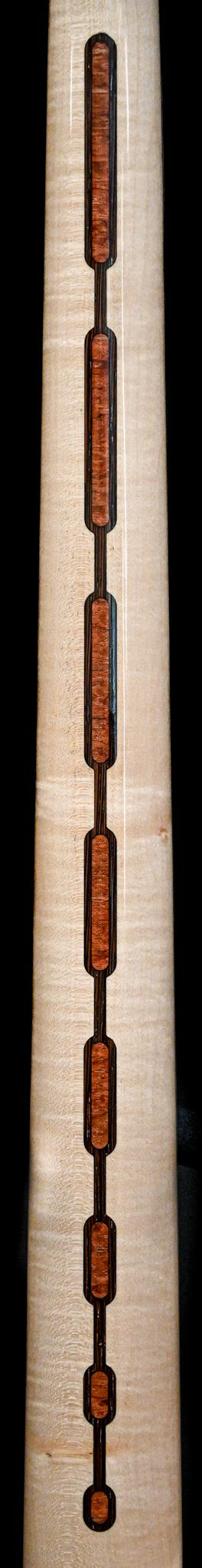 Detailed close-up of wooden inlay work on Belforti Marē 4 - Signature instrument neck, showcasing craftsmanship and design.