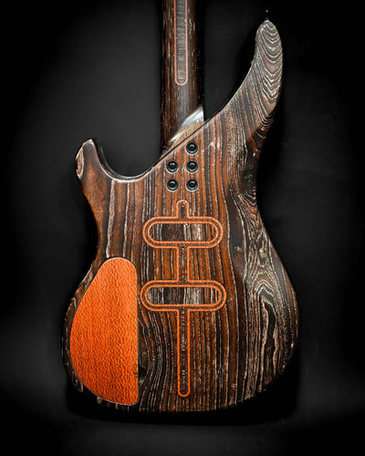 Side view of the back of the S3 Lacewood bass guitar, highlighting the stunning wood grain and features.