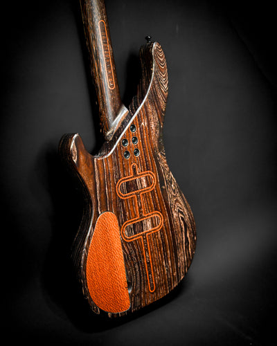 Dynamic angle of the back of the S3 Lacewood bass guitar, highlighting its unique craftsmanship and features.