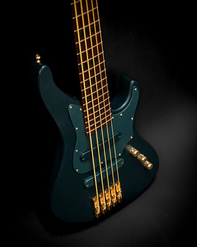 Marē 5 - Essential bass guitar by Belforti with gold hardware on a black background