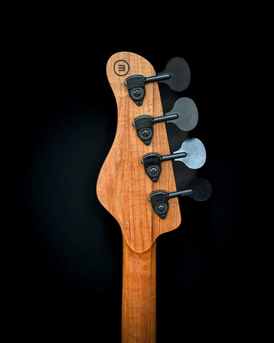 Image showcasing the back view of M3 Maple bass guitar, emphasizing its finish and design.