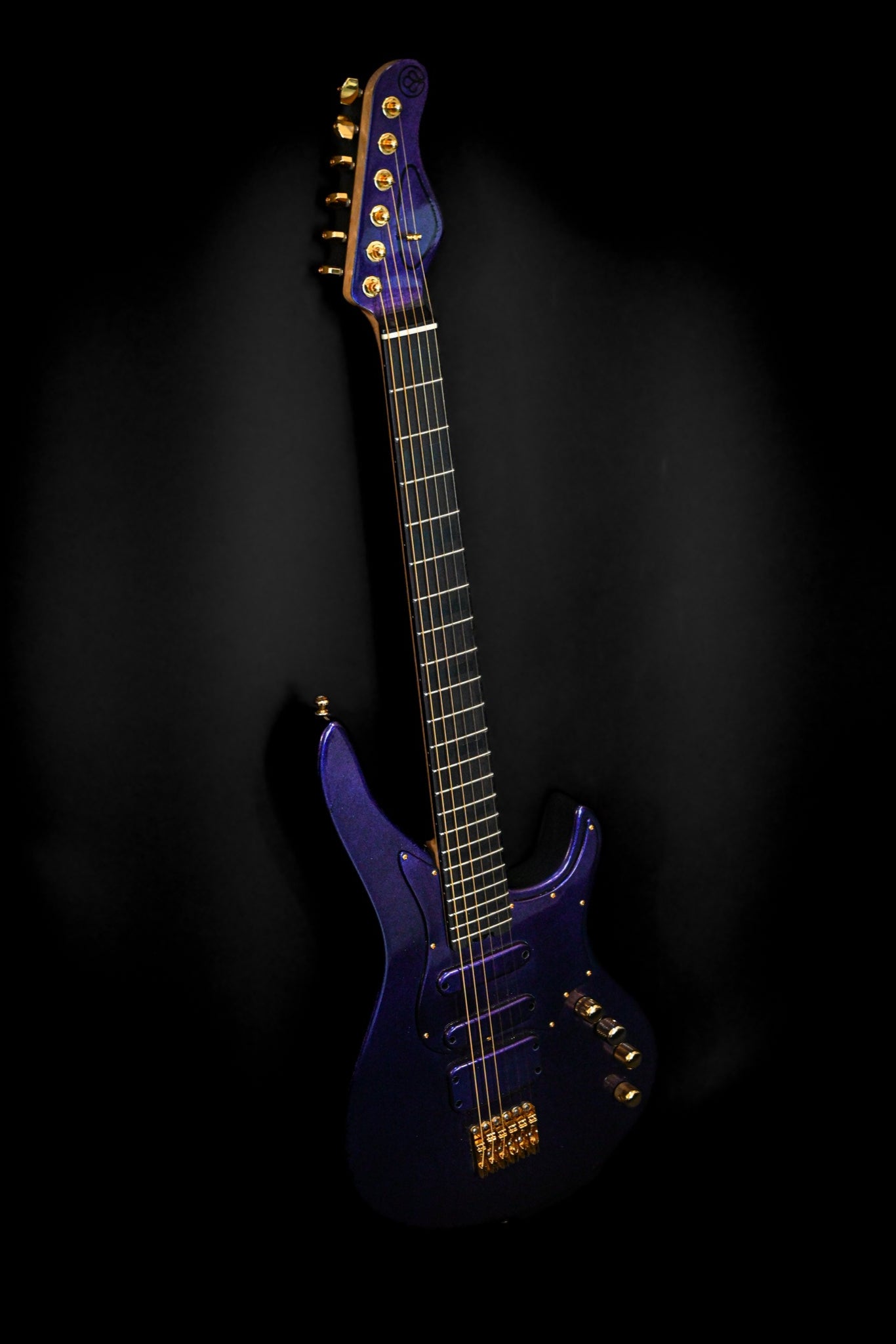 E7 - Cosmo (Colorshift) guitar featuring a vibrant blue-to-purple finish against a black backdrop.