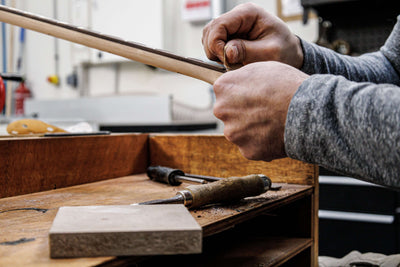 Luthier Marin Nourry Belforti of Belforti Instruments sanding a Belforti Bass Neck