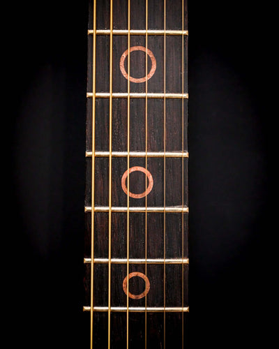 Side view of the S5 Active - Elm Burl guitar emphasizing the curvature and grain of the wood.